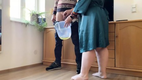 Dear mother-in-law takes off her panties and pees with her legs wide open in a bucket next to her son-in-law