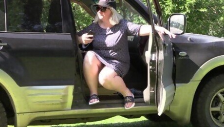 Under the skirt of a mature bbw sitting in a car.